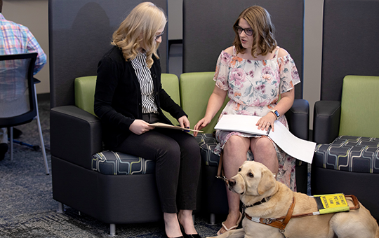 Woman with service dog having a meeting